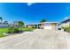 Ranch-style home with stone accents and a spacious front yard at 703 Portia N St, Nokomis, FL 34275