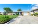 Charming ranch house featuring a well-manicured lawn and driveway at 703 Portia N St, Nokomis, FL 34275