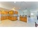 Open concept kitchen with granite countertops and oak cabinets at 703 Portia N St, Nokomis, FL 34275