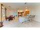 Kitchen with granite countertop, breakfast bar, and wood cabinets at 703 Portia N St, Nokomis, FL 34275