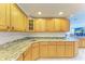 Spacious kitchen featuring granite countertops and oak cabinetry at 703 Portia N St, Nokomis, FL 34275