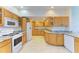Modern kitchen with granite countertops and oak cabinets at 703 Portia N St, Nokomis, FL 34275