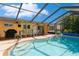 Relaxing kidney-shaped pool with a screened enclosure and patio area at 18069 Ohara Dr, Port Charlotte, FL 33948