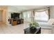 Bright living room features tiled floors and a comfy couch at 18069 Ohara Dr, Port Charlotte, FL 33948