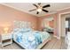 Bright bedroom with a ceiling fan, mirrored closet, and ensuite bathroom access at 18069 Ohara Dr, Port Charlotte, FL 33948