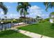 Private boat dock with lush green lawn and canal views at 18069 Ohara Dr, Port Charlotte, FL 33948