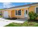 Quaint light orange home with attached garage and lush landscaping at 18069 Ohara Dr, Port Charlotte, FL 33948