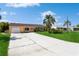 Single-story home with a long driveway and a manicured lawn at 18069 Ohara Dr, Port Charlotte, FL 33948