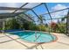 Inviting kidney-shaped pool with a screened enclosure at 18069 Ohara Dr, Port Charlotte, FL 33948