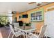 Covered patio with seating area, ceiling fans, and outdoor kitchen at 18069 Ohara Dr, Port Charlotte, FL 33948