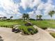 Golf course view with palm trees and golf carts at 5221 Laurel Oak Ct, North Port, FL 34287