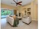 Light and airy living room with comfortable seating and pool access at 5221 Laurel Oak Ct, North Port, FL 34287