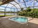 Screened-in pool and spa overlooking a lake at 5221 Laurel Oak Ct, North Port, FL 34287