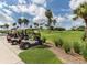 Golf carts parked near a lush green golf course at 5221 Laurel Oak Ct, North Port, FL 34287