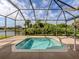 Relaxing screened pool and spa with a tranquil backyard view at 5221 Laurel Oak Ct, North Port, FL 34287