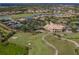 Aerial view of community with clubhouse, golf course, and homes at 5221 Laurel Oak Ct, North Port, FL 34287