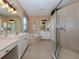 Elegant bathroom with a soaking tub, double vanity, and walk-in shower at 5221 Laurel Oak Ct, North Port, FL 34287