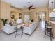 Spacious living room featuring a comfortable sofa and access to the pool at 5221 Laurel Oak Ct, North Port, FL 34287