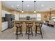 Kitchen boasts granite countertops, island with seating, and stainless steel appliances at 5221 Laurel Oak Ct, North Port, FL 34287