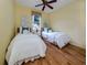 Guest bedroom with two twin beds and wood floors at 5221 Laurel Oak Ct, North Port, FL 34287