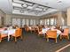 Community dining room with tables, chairs, and elegant decor at 5221 Laurel Oak Ct, North Port, FL 34287