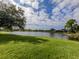 Scenic lake view with lush landscaping and neighboring homes at 5221 Laurel Oak Ct, North Port, FL 34287