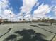 Well-maintained tennis court with a covered seating area at 5221 Laurel Oak Ct, North Port, FL 34287