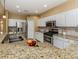 Modern kitchen with granite countertops and stainless steel appliances at 5221 Laurel Oak Ct, North Port, FL 34287
