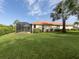 Landscaped backyard with a screened pool and lush greenery at 5221 Laurel Oak Ct, North Port, FL 34287
