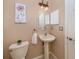 Small powder room with pedestal sink and toilet at 5221 Laurel Oak Ct, North Port, FL 34287