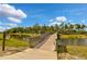 Wooden footbridge over a tranquil waterway at 12196 Alachua Ln, Venice, FL 34293