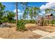 Community playground with wooden playset and picnic tables at 12196 Alachua Ln, Venice, FL 34293