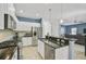 Eat-in kitchen with white cabinets, granite countertops and stainless steel appliances at 12196 Alachua Ln, Venice, FL 34293