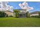 Home exterior view showcasing a spacious backyard at 12196 Alachua Ln, Venice, FL 34293