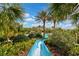 Blue waterslide curving through lush landscaping at 12196 Alachua Ln, Venice, FL 34293