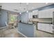 Modern kitchen featuring white cabinets, granite countertops, and stainless steel appliances at 12196 Alachua Ln, Venice, FL 34293