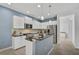 Modern kitchen with white cabinets, granite countertops, and stainless steel appliances at 12196 Alachua Ln, Venice, FL 34293