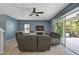 Living room with a sectional sofa, fireplace, and sliding glass doors to a patio at 12196 Alachua Ln, Venice, FL 34293