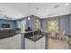 Kitchen with white cabinets, granite countertops, stainless steel appliances, and an island at 12196 Alachua Ln, Venice, FL 34293