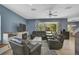 Living area featuring a grey sectional, fireplace, and sliding doors to a patio at 12196 Alachua Ln, Venice, FL 34293