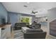 Open living room with grey sectional sofa, a fireplace, and access to a screened patio at 12196 Alachua Ln, Venice, FL 34293