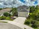 Two-story house with a large driveway and landscaped yard at 12196 Alachua Ln, Venice, FL 34293