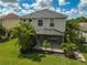 Two-story home with screened patio and tropical landscaping at 12196 Alachua Ln, Venice, FL 34293