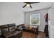 Small bedroom with a twin bed and leather couch at 12196 Alachua Ln, Venice, FL 34293