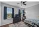 Bright bedroom featuring two windows and a dresser at 12196 Alachua Ln, Venice, FL 34293