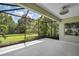 Spacious screened patio with ceiling fan, overlooking a lush green backyard at 12196 Alachua Ln, Venice, FL 34293