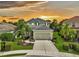Two-story house with landscaped yard and attached garage at sunset at 12196 Alachua Ln, Venice, FL 34293