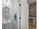 Clean powder room with pedestal sink and wood-paneled accent wall at 12196 Alachua Ln, Venice, FL 34293