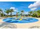 Community spray park with palm trees and colorful features at 12196 Alachua Ln, Venice, FL 34293