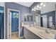 Double vanity bathroom with large mirror and shower at 12196 Alachua Ln, Venice, FL 34293
